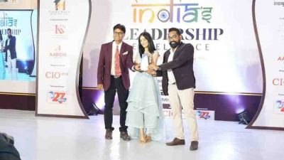“The owners of CallerDesk receive the award for Best Cloud Telephony Platform at the India Leadership Excellence event. Two male founders stand on stage alongside a female presenter, holding the trophy together in front of the event backdrop.”