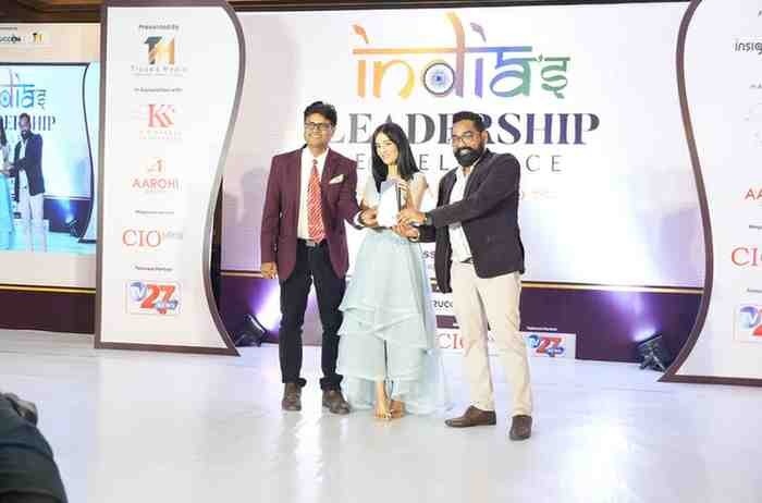 “The owners of CallerDesk receive the award for Best Cloud Telephony Platform at the India Leadership Excellence event. Two male founders stand on stage alongside a female presenter, holding the trophy together in front of the event backdrop.”