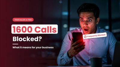 Shocked businessman looking at his phone as a 1600 series business call shows a Frequently Blocked warning on Truecaller